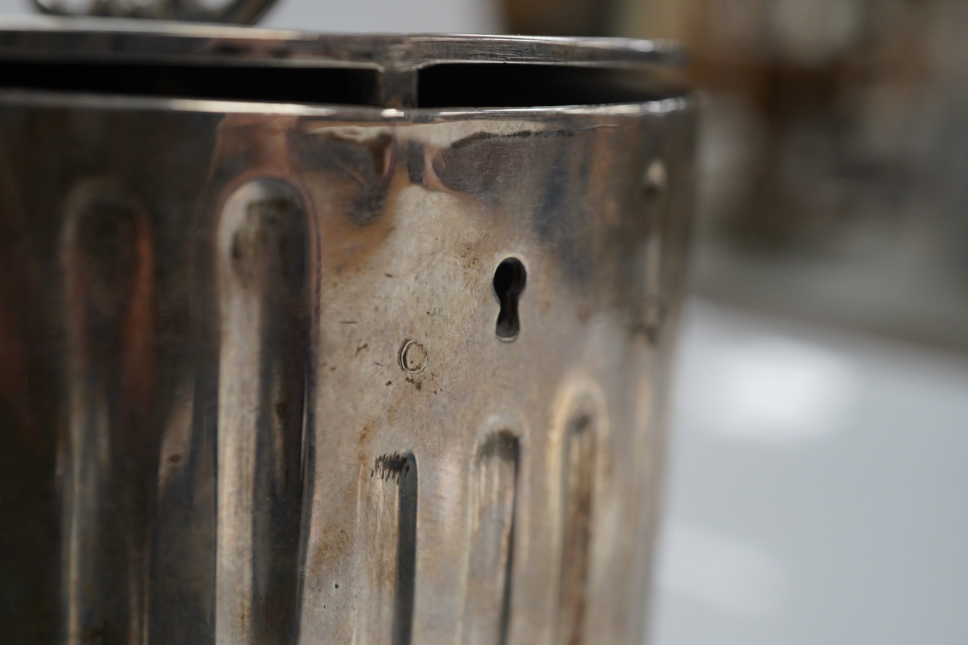 A George III fluted silver lead lined circular tea caddy, by Walter Tweedie, London, 1772, height 10cm excluding handle. Condition - poor